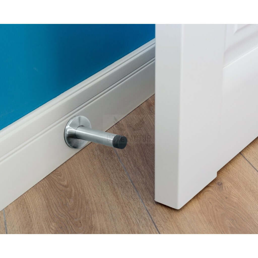 Long adhesive door stop mounted on a skirting board